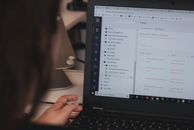 Close up of person working at open laptop screen